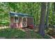 Storage shed nestled among the trees at 1828 Pitts Chapel Rd, Newborn, GA 30056