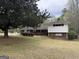 Charming single-story home with a well-maintained lawn, mature trees, and a welcoming patio area at 362 Mayfield Cir, Alpharetta, GA 30009