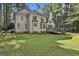 Rear exterior showcasing the deck, chimney, and large, well-maintained backyard at 1202 Loxley Cir, Peachtree City, GA 30269
