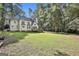 A spacious, green backyard with mature trees and manicured lawn at 1202 Loxley Cir, Peachtree City, GA 30269