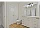 Bathroom boasts updated vanity with marble top and hardwood floors at 1202 Loxley Cir, Peachtree City, GA 30269