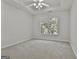Bedroom with carpeted floors, ceiling fan, and natural light from one large window at 1202 Loxley Cir, Peachtree City, GA 30269