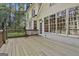 An expansive wooden deck off the rear of the house with multiple windows, overlooking the backyard at 1202 Loxley Cir, Peachtree City, GA 30269