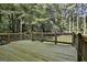 Wooden deck overlooking a beautiful, lush, wooded backyard at 1202 Loxley Cir, Peachtree City, GA 30269
