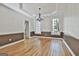 Elegant dining room with hardwood floors, chandelier, and large windows at 1202 Loxley Cir, Peachtree City, GA 30269