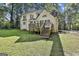Exterior view of the home showcasing a deck, backyard and architectural details at 1202 Loxley Cir, Peachtree City, GA 30269