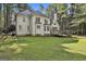 The rear of the house displays a well-maintained lawn, mature trees, and an inviting deck at 1202 Loxley Cir, Peachtree City, GA 30269