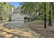 View of the attached two-car garage and long driveway, set amongst lush greenery at 1202 Loxley Cir, Peachtree City, GA 30269