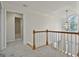 Upstairs hallway with railing overlooks the living room and foyer with chandelier at 1202 Loxley Cir, Peachtree City, GA 30269