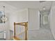 Hallway with chandelier overlooks foyer and living room area at 1202 Loxley Cir, Peachtree City, GA 30269
