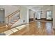 Bright living room featuring hardwood floors, staircase, and crown molding details at 1202 Loxley Cir, Peachtree City, GA 30269