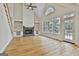 Bright living room features a stone fireplace, built-in shelving, and large windows at 1202 Loxley Cir, Peachtree City, GA 30269