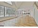 Open living space with hardwood floors, lots of light and kitchen in background at 1202 Loxley Cir, Peachtree City, GA 30269