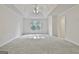 Spacious main bedroom features neutral walls, tray ceiling and carpeted floors at 1202 Loxley Cir, Peachtree City, GA 30269