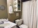 Bathroom featuring a vanity, toilet, and a decorative shower curtain at 486 Village Cir, Stockbridge, GA 30281