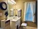 Bright bathroom with a large mirror, vanity, and a window at 486 Village Cir, Stockbridge, GA 30281