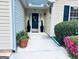 Welcoming entrance with a decorated front door and manicured landscaping at 486 Village Cir, Stockbridge, GA 30281