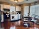 Well-lit kitchen with stainless appliances, white cabinets, and wood flooring at 486 Village Cir, Stockbridge, GA 30281