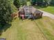 Aerial view of a home featuring a deck, a spacious yard, mature trees and brick accents at 611 Bernhard Rd, Fayetteville, GA 30215