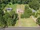 Aerial view of a house featuring a lush green lawn, mature trees, and plenty of privacy at 611 Bernhard Rd, Fayetteville, GA 30215