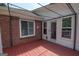 A cozy back porch features a pergola, brick accents and a wooden deck at 611 Bernhard Rd, Fayetteville, GA 30215