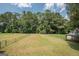 Expansive, fenced backyard with a lush lawn, mature trees, and plenty of space at 611 Bernhard Rd, Fayetteville, GA 30215