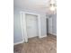 A bright bedroom features a closet with folding doors and a ceiling fan at 611 Bernhard Rd, Fayetteville, GA 30215