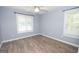 A cozy bedroom is bright with natural light, hardwood floors and a ceiling fan at 611 Bernhard Rd, Fayetteville, GA 30215