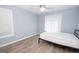 Spare bedroom with light gray walls, two windows, and wood-look floors at 611 Bernhard Rd, Fayetteville, GA 30215
