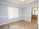 Bright dining room featuring hardwood floors, chair railing, and fresh paint at 611 Bernhard Rd, Fayetteville, GA 30215