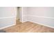 Bright dining room featuring hardwood floors, chair railing, and fresh paint at 611 Bernhard Rd, Fayetteville, GA 30215