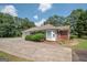 Charming brick home with a large driveway, surrounded by mature trees at 611 Bernhard Rd, Fayetteville, GA 30215