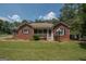 Charming brick home with a welcoming screened front porch and manicured lawn at 611 Bernhard Rd, Fayetteville, GA 30215