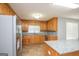 Spacious kitchen with granite countertops, wooden cabinets, and stainless steel appliances at 611 Bernhard Rd, Fayetteville, GA 30215