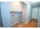 Functional laundry room features hardwood floors, storage, and utility connections at 611 Bernhard Rd, Fayetteville, GA 30215
