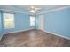Spacious bedroom features light blue walls, light gray floors, and a ceiling fan at 611 Bernhard Rd, Fayetteville, GA 30215