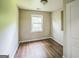Cozy bedroom featuring wood-look flooring, neutral paint, and a window providing natural light at 3260 Russell St, Hapeville, GA 30354