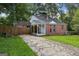 Charming brick home with a covered front porch and a driveway at 3260 Russell St, Hapeville, GA 30354