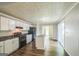 Well-lit kitchen featuring an island sink, black appliances, and hardwood floors at 3260 Russell St, Hapeville, GA 30354