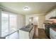 Well-lit kitchen featuring an island sink, black appliances, and hardwood floors at 3260 Russell St, Hapeville, GA 30354