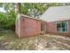 Brick patio with a brick wall and glimpses of a green backyard and trees, perfect for outdoor enjoyment at 3260 Russell St, Hapeville, GA 30354