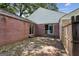 Brick patio with brick home, white roof and views to other rooms through windows and sliding glass door at 3260 Russell St, Hapeville, GA 30354