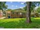 Brick home featuring a lush green lawn and a large tree providing shade at 1381 Sharon Sw St, Atlanta, GA 30314