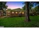 Back view of a brick home with a covered parking area and lush green grass at 1381 Sharon Sw St, Atlanta, GA 30314