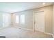 The spacious living room has neutral paint and carpet with two exterior doors at 1381 Sharon Sw St, Atlanta, GA 30314
