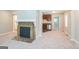 Bright living room featuring a fireplace and access to the adjacent kitchen and dining area at 1381 Sharon Sw St, Atlanta, GA 30314