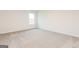 This bedroom offers a carpeted floor and a view to the exterior at 244 Oliver Dr, Locust Grove, GA 30248