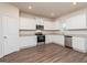 Modern kitchen featuring white cabinets, granite countertops, and stainless steel appliances and hardwood floors at 244 Oliver Dr, Locust Grove, GA 30248