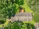 Aerial view of a home featuring a gray roof, wooden deck, and lush green backyard at 100 Homestead Pl, Rex, GA 30273