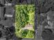 An aerial view displays a verdant neighborhood with tree-lined streets and well-maintained homes at 100 Homestead Pl, Rex, GA 30273